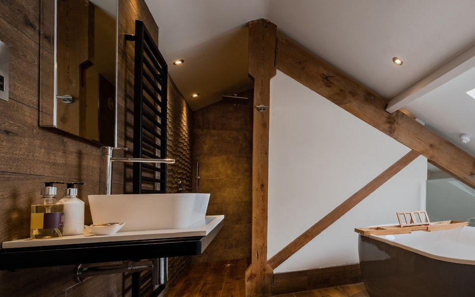 Luxury bathroom with freestanding bath and wall hung sink.