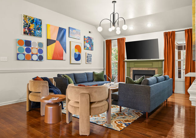 Rally Point short term rental living room in Clarksville, TN with fireplace, colorful artwork, and seating for groups
