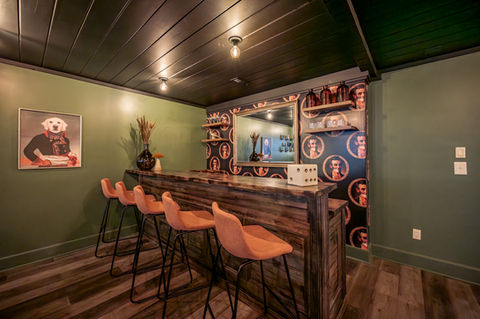 Bluff Mountain luxury vacation rental in Pigeon Forge featuring custom bar, dramatic lighting, and group entertainment space