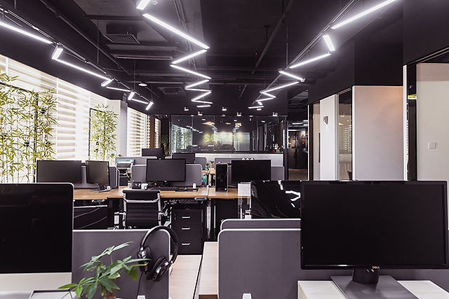 Modern open workspace at SOMOS plenty of natural light and plants