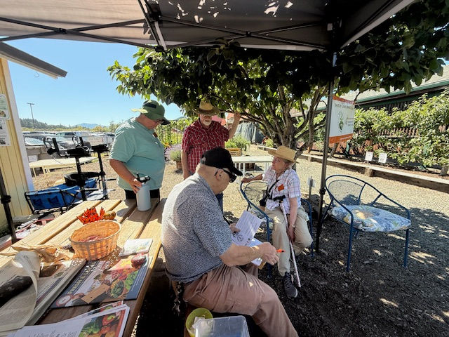 MGs Rosalind, David, Gil and Ann working at the Benton County Fair