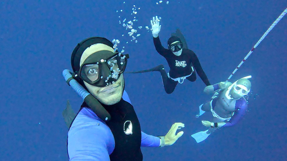 Selfie of three freedivers at a depth of 20 metres.
