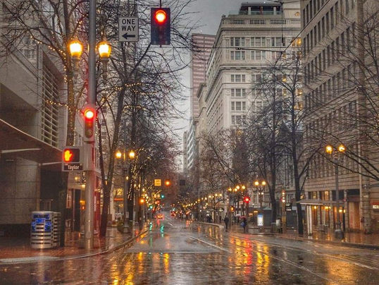 Rainy Portland street at dusk, symbolizing the emotional distance of the Portland Freeze