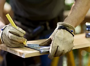 Carpenter Measuring Wood.webp