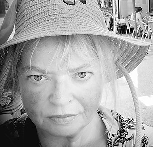 This is a photograph of the artist in black and white. She is wearing a hat