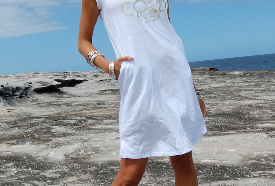 Cute tee shirt dress with coco cartel detail on front V neck line White Tee shirt style Easy fit Cap sleeve Pockets 100% Cot