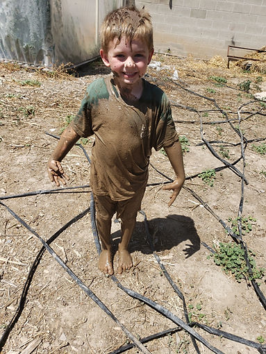 Child covered in mud