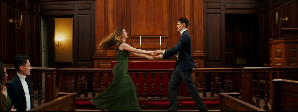 Man and woman dancing in a formal wood-paneled hall