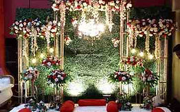 Elegant flower decoration with floral backdrop and decorative lighting for a wedding or special event in Kolkata.