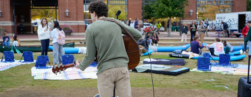 A musician playing music for a group.