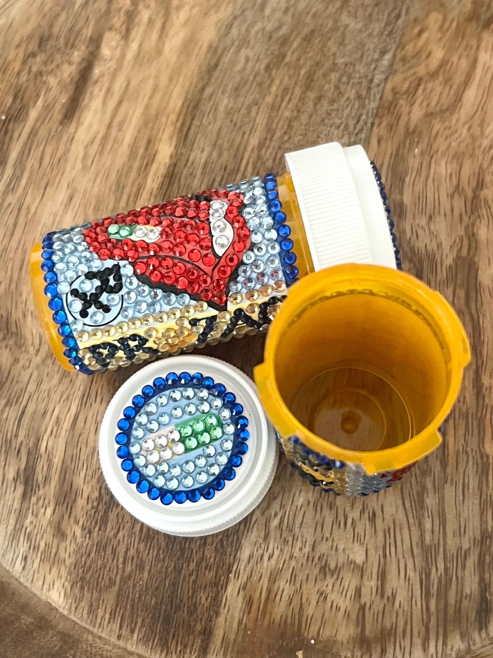 Thumbnail: Bedazzled pill bottle with a red lips design and Prozac logo. jonathan adler inspired