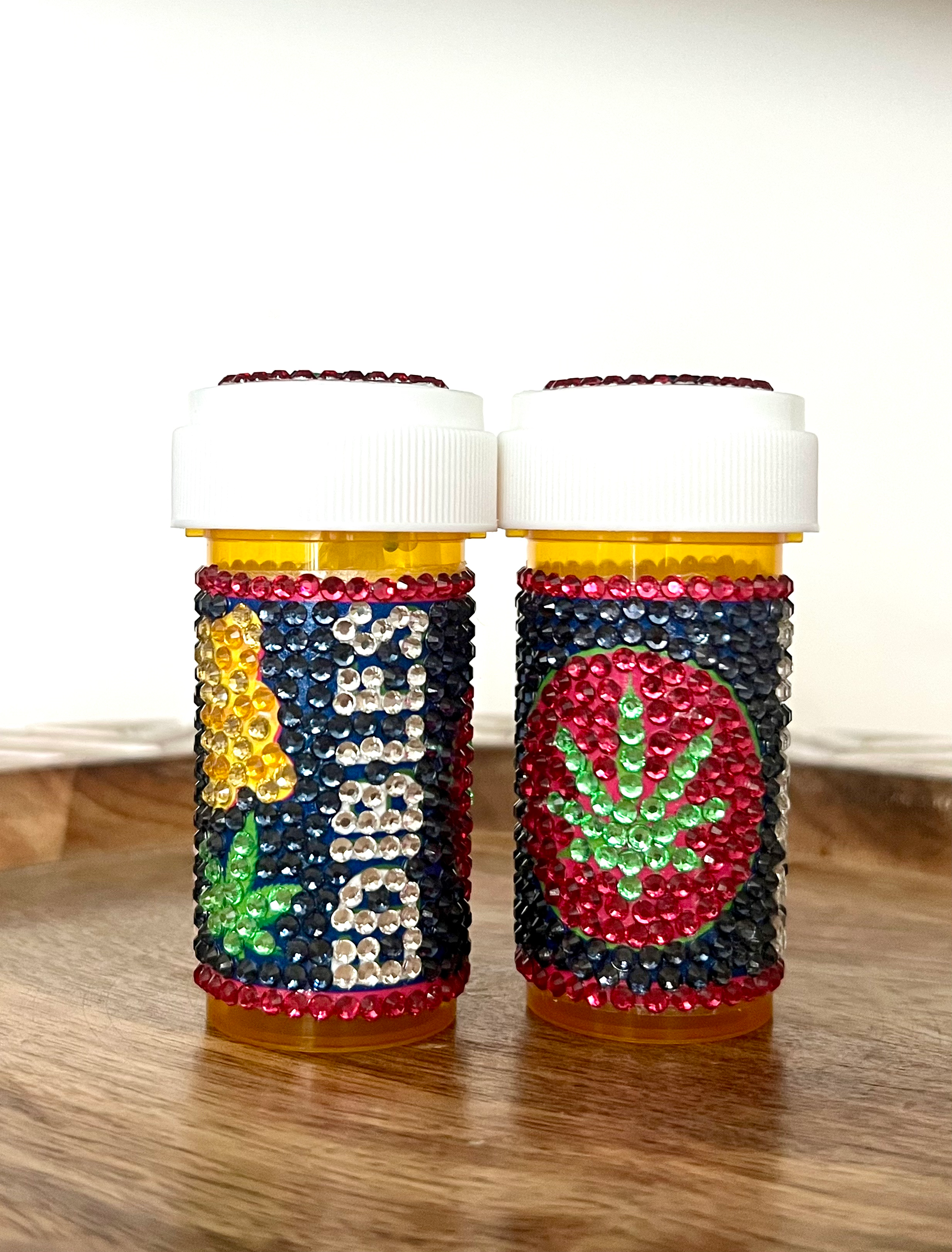 bedazzled pill bottle with a gummy bear and green marijuana leaf design, with rhinestones, perfect for storing edibles