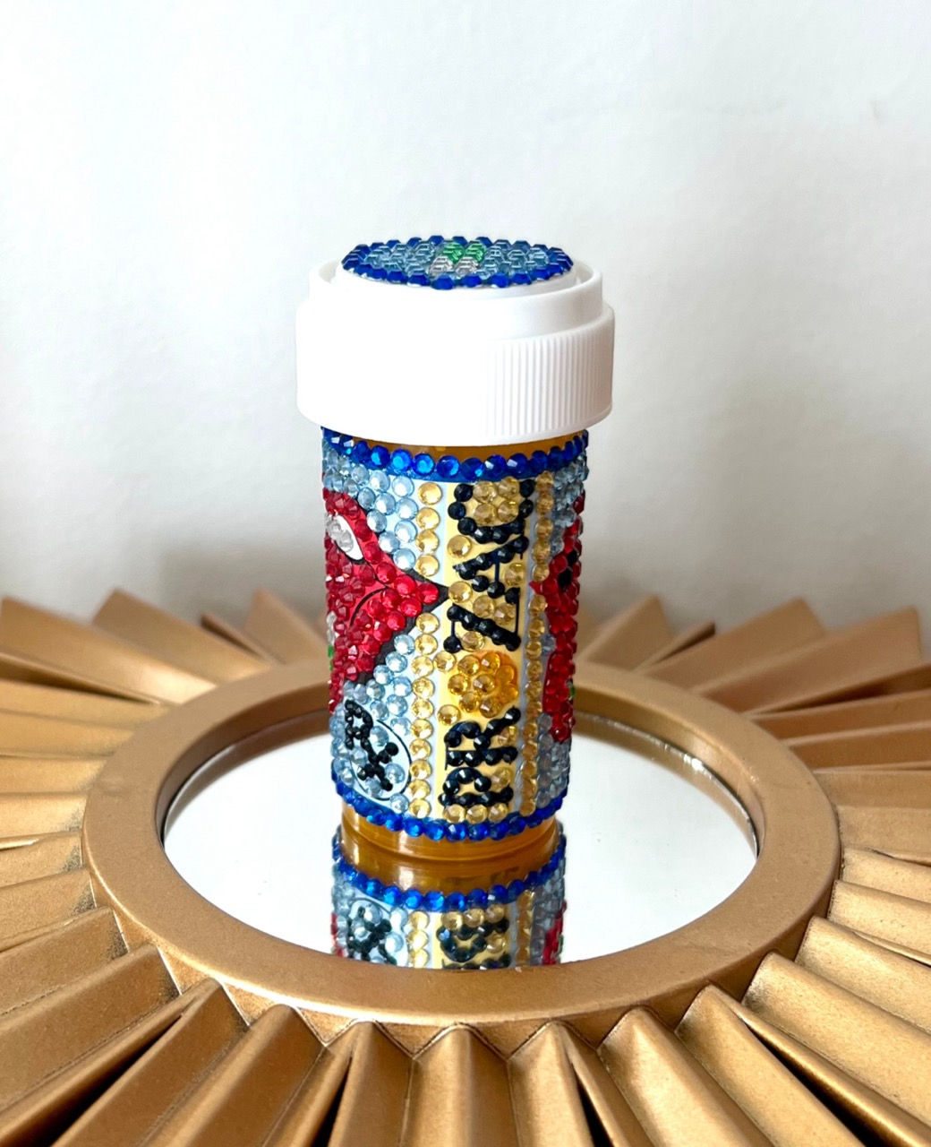 Bedazzled pill bottle with a red lips design and Prozac logo. jonathan adler inspired