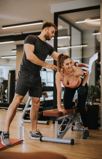 attractive-woman-personal-trainer-with-weight-training-gym.jpg