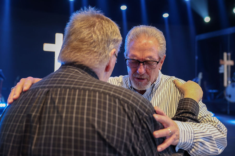 Gary Chavez praying for a gentleman after Sunday service in the sanctuary of Damascus Road community Church in Mount Airy, MD