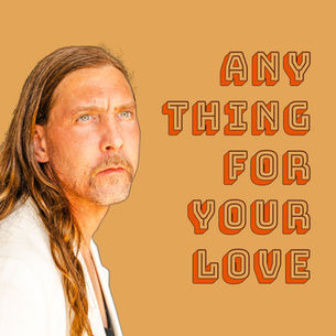 This is the cover for Paul Schalda's, "Anything For Your Love" single showing Schalda with long hair gazing contemplatively into the distance, wearing a light jacket, against a tan background. Text reads "Anything for Your Love."