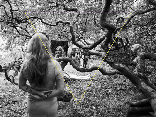 The cover for Dao Strom's, Tender Revolutions album, showing a black and white forest scene with twisted tree branhes, with cut and collaged images of Strom standing or reclining. There is a large, upside down yellow triangle outline in the centre. Calm, mystical mood.