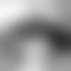 The cover for Canadian artist -Pete Standing Alone's, "hay song" single, showing her in black shirt laying on table with apples, appearing contemplative. Black and white setting, creating a calm, introspective mood.