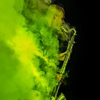  playing sax with steam or smoke coming off his body.