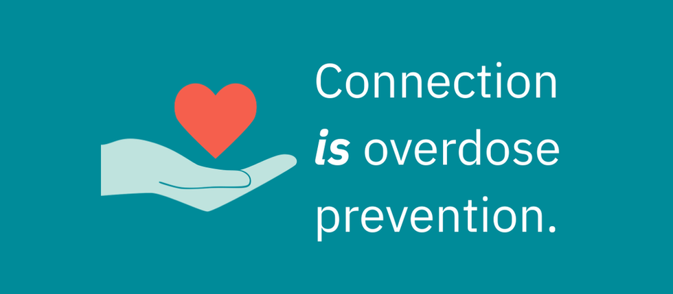 A dark teal background with a light teal hand holding a red-orange heart. The text reads: Connection is overdose prevention.