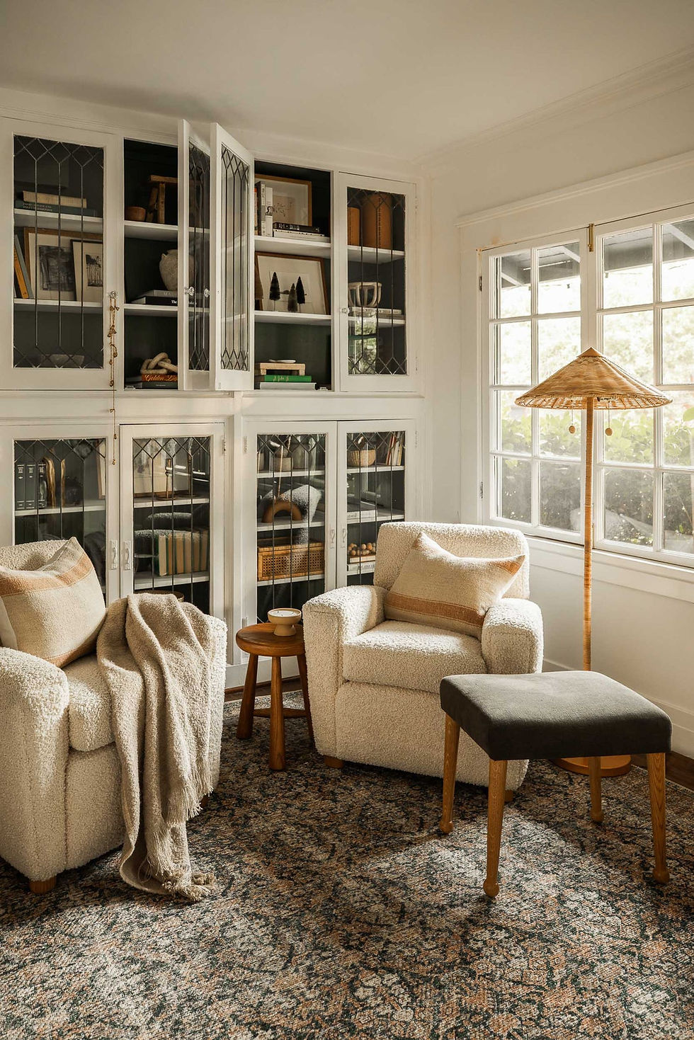 cozy reading nook with two soft armchairs and a bookshelf.