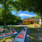 Rævehuset med terrasse og minigolfbaner foran.