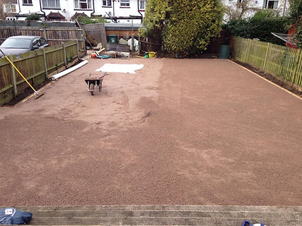screed garden surface to prepare garden for fake grass artificial turf lawn installation