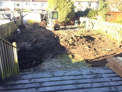 lawn turf soil grass being digged up from a rear garden to prepare for artificial turf lawn grass installation