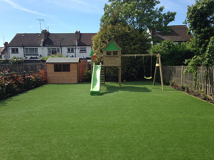Artificial grass fake turf in garden finished install with wooden play house