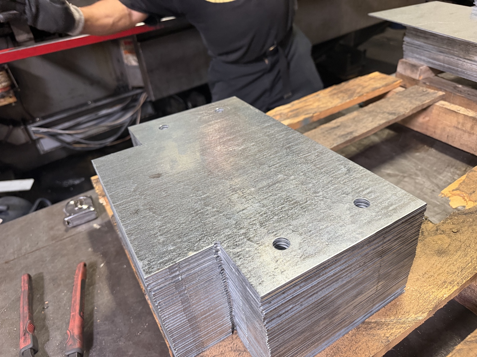 Stack of notched metal plates with punched mounting holes