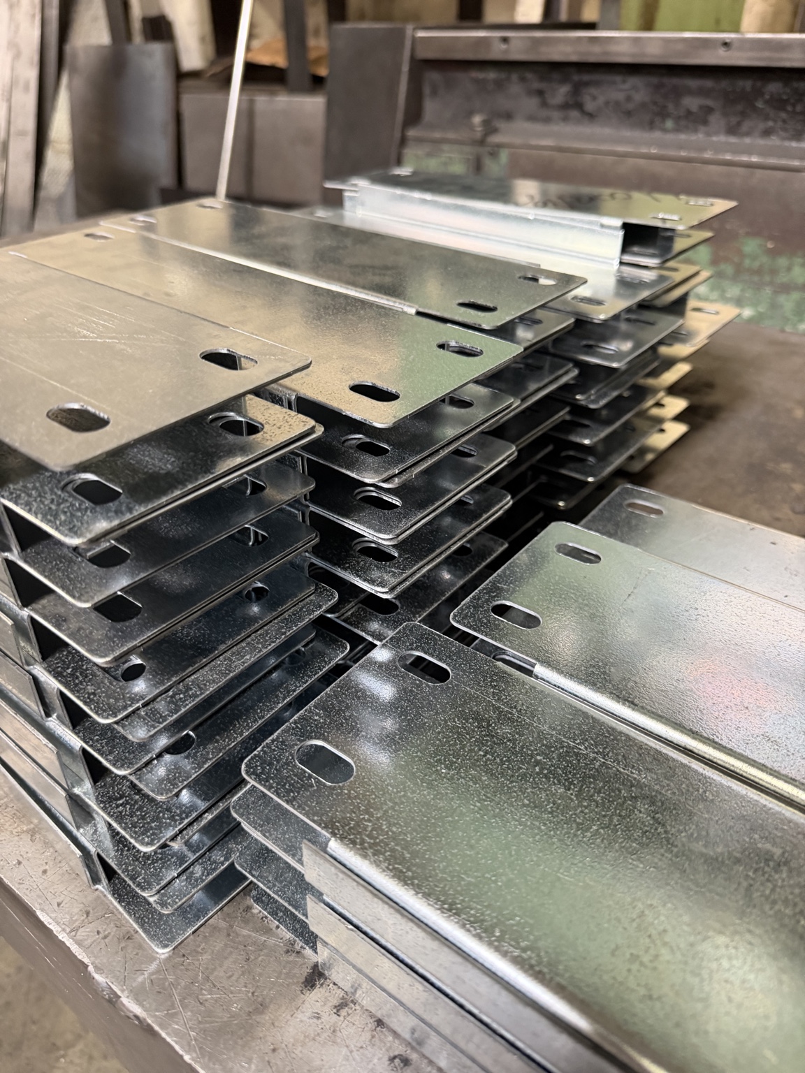 Stacks of formed metal components with oblong punched slots