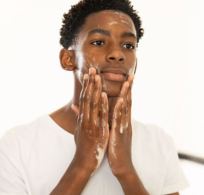 South African teenager wasing his face with Upenya Exfoliating Cleanser