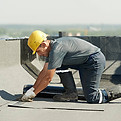 Man working on commercial flat roof