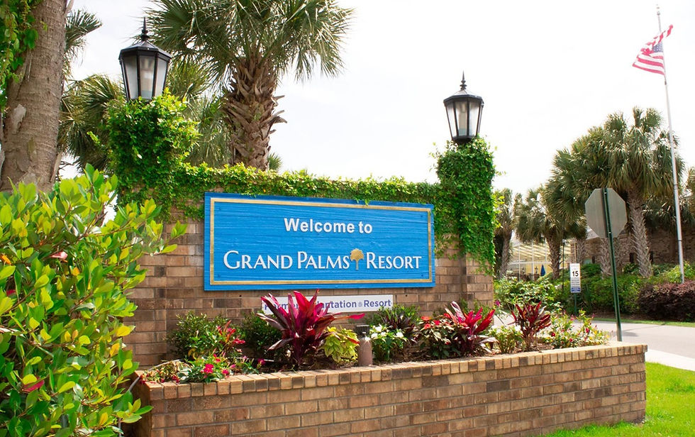 A big sign reading "Welcome to Grand Palms Resort"
