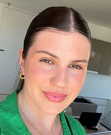 A photo of our tutor Brodie, she is a young woman in her twenties with brown hair and brown eyes who is smiling. 