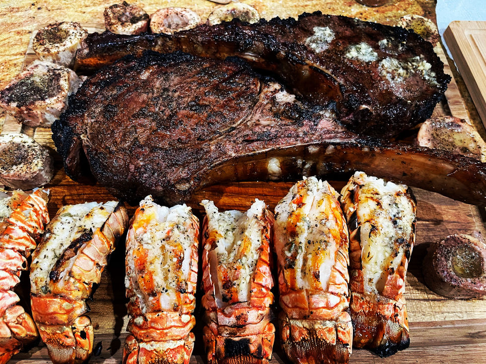 Wood-smoked tomahawk ribeyes with lobster and bone marrow