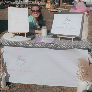 The Sadie's Purpose President, Danielle with the booth at a fall festival fundraiser.