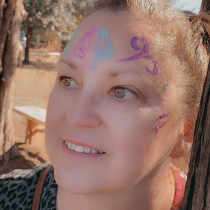 A woman with a design painted on her face.