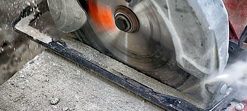 Power Circular Saw Blade Cutting Fresh Concrete