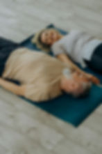 happy couple lying on yoga mats