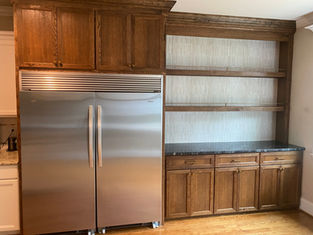 Custom stained oak kitchen cabinetry around refrigerator with dry bar, Wake County NC