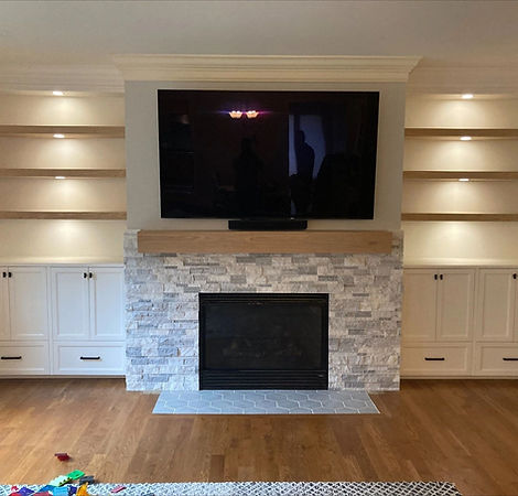 Fireplace built-ins wit white cabinets and lighted shelves on both sies of the fireplace, Raleigh NC