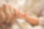 Baby holding parent pinky finger