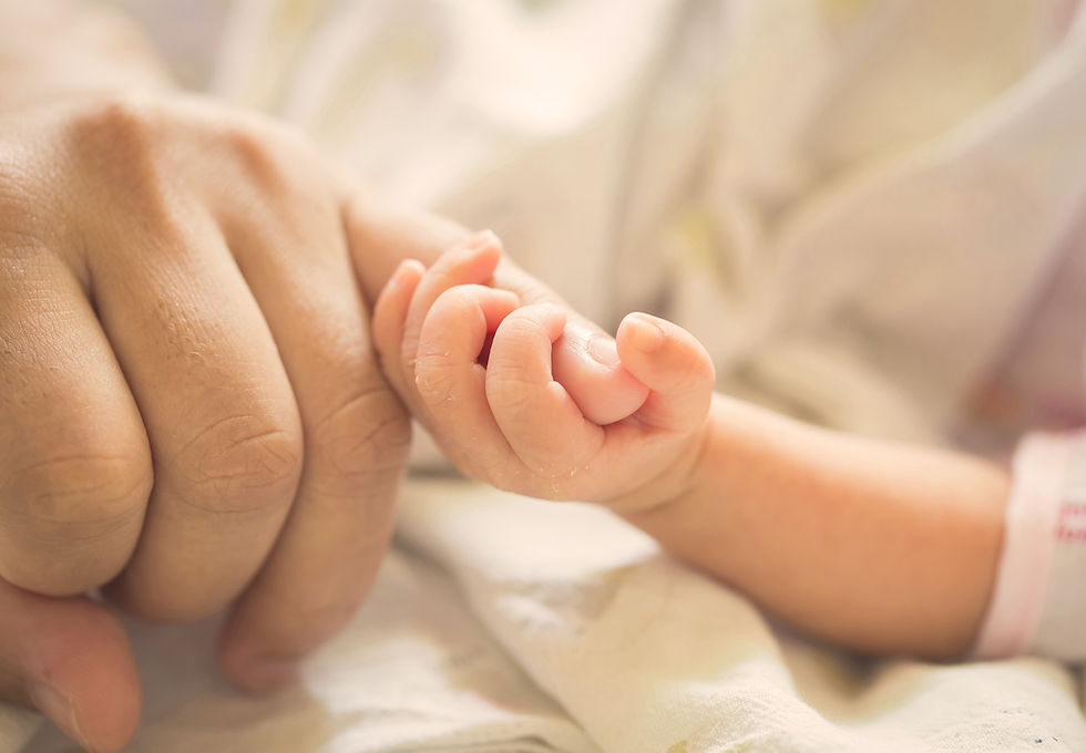 Baby holding parent pinky finger