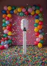 The Salsa booth facing a pink background surrounded with ballons