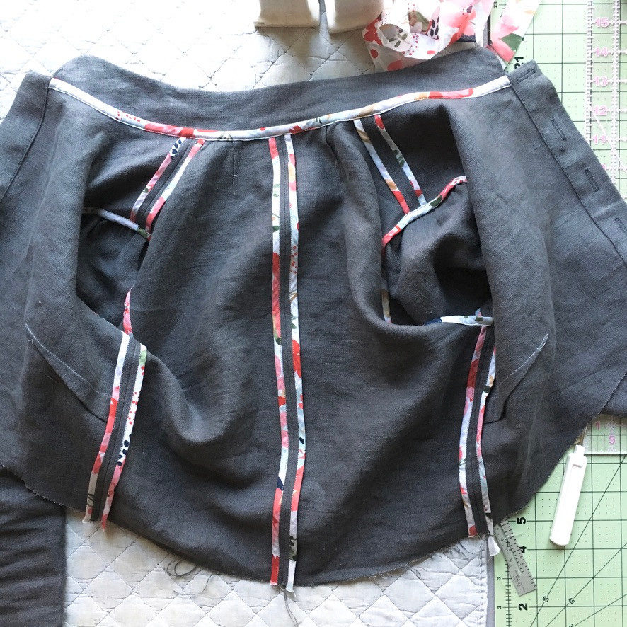 This image shows decorative bound seams inside a linen dress, under construction. n