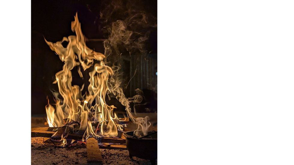 A small black cauldron holding a smoking incense sits in front of an active open-air fireplace.