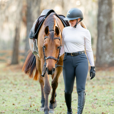Woman and bay horse walking together