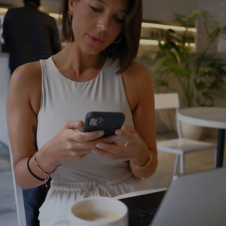 Maria De La Fuente is busy working on her phone.