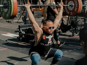 A lifter mid barbell squat, straining under load